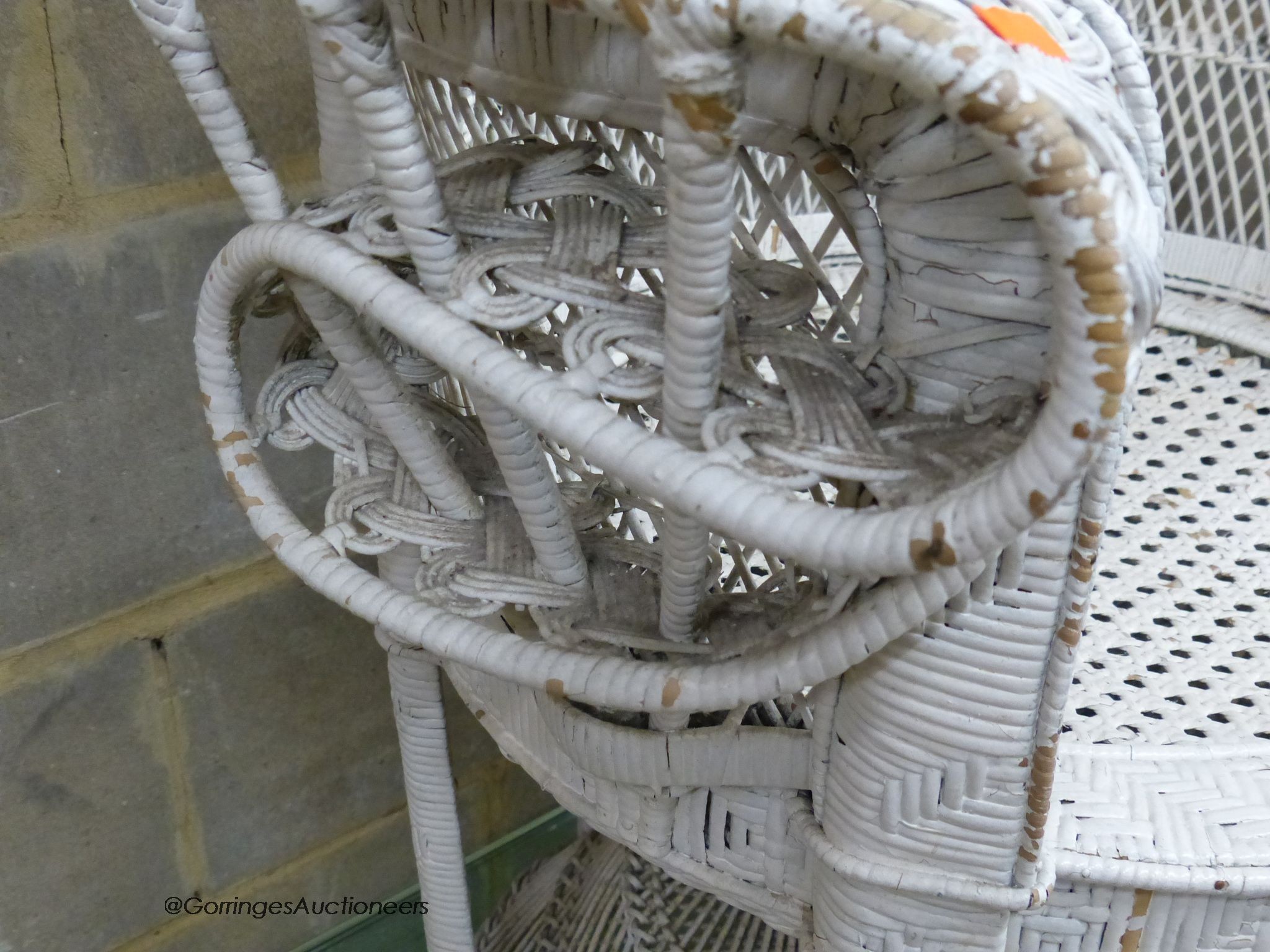 A white painted wickerwork peacock armchair, width 110cm, height 146cm